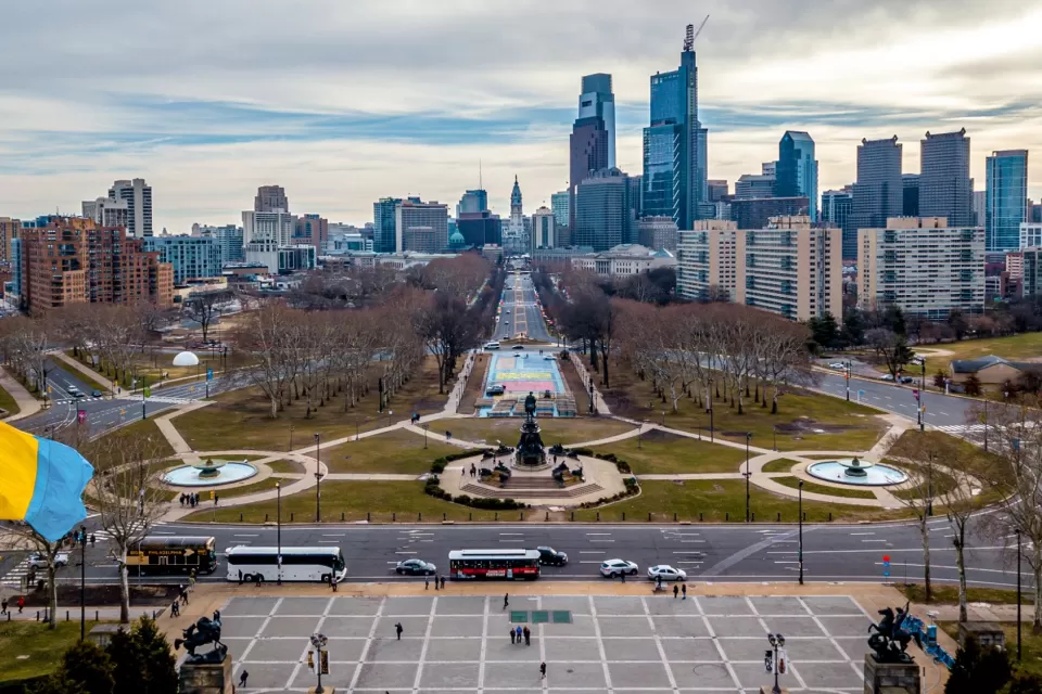 Looking down from the Philadelphia Museum of Art, the Benjamin Franklin Parkway runs vertically through the skyline to the Washington Monument by Rudolf Siemering.